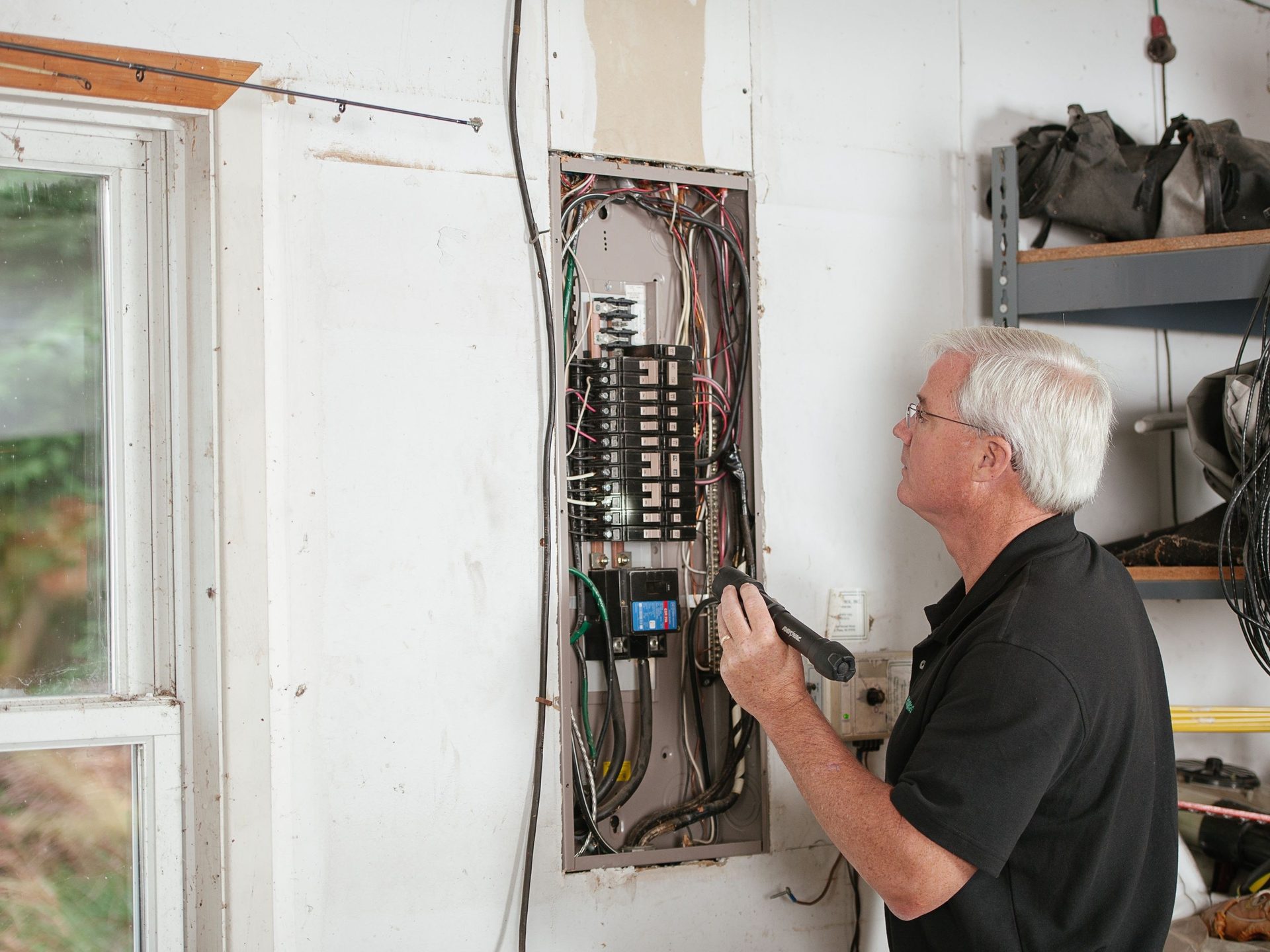 Electrician inspecting a consumer unit
