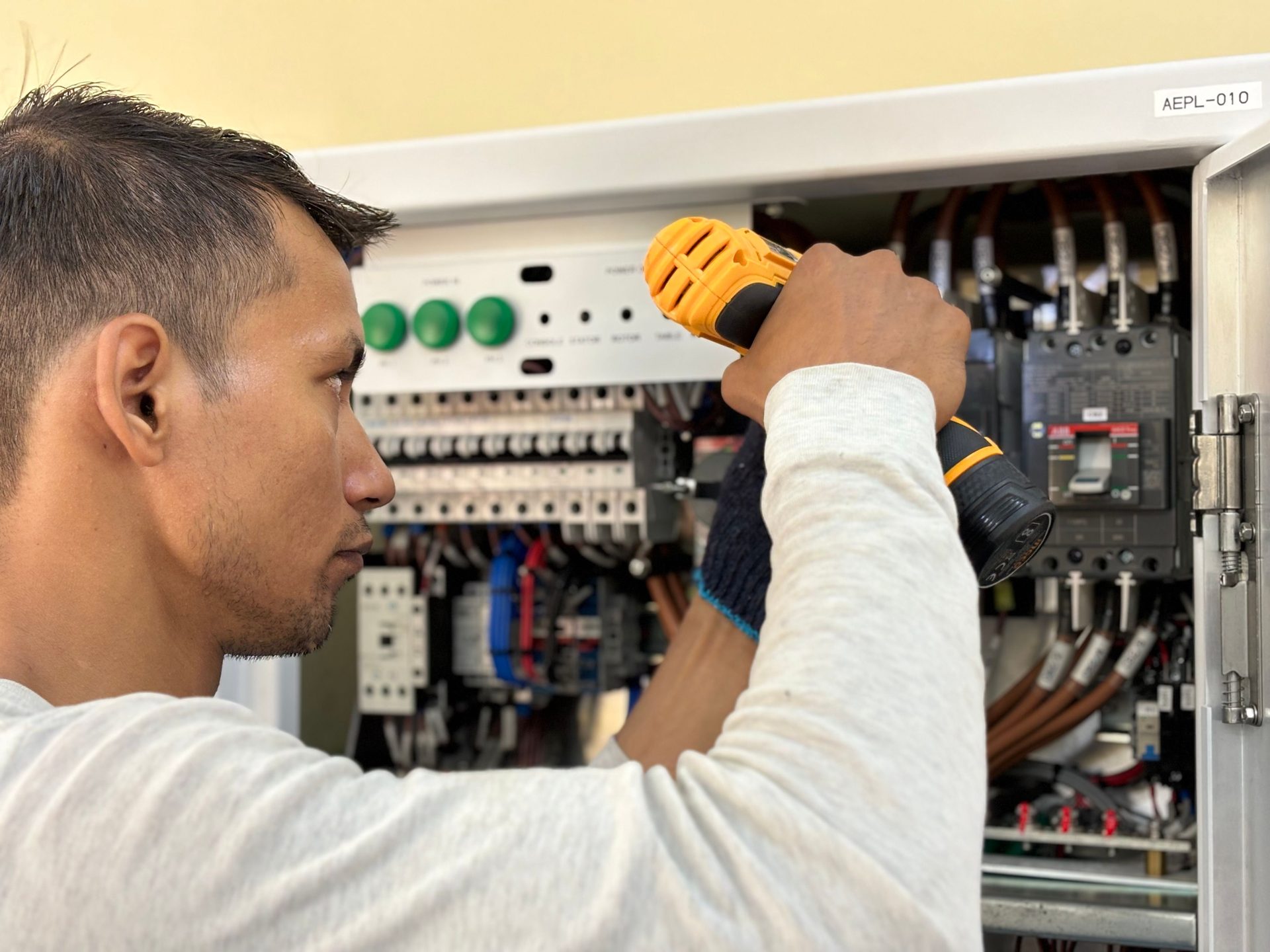 Electrician working on a commercial distribution board