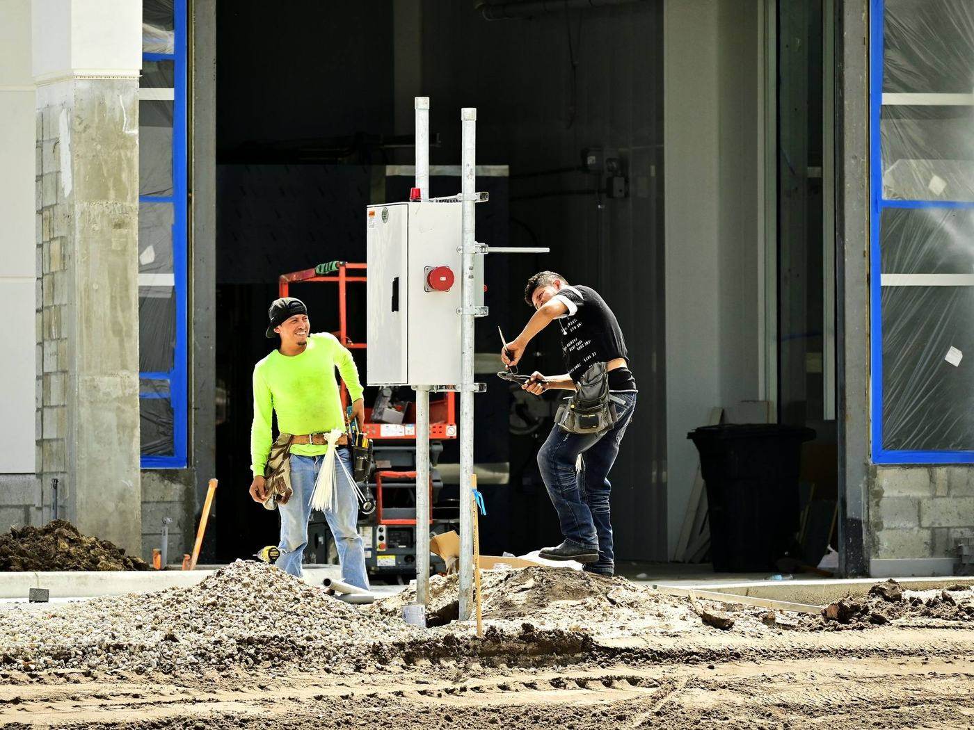 TLECC engineers installing an electrical distribution panel on site